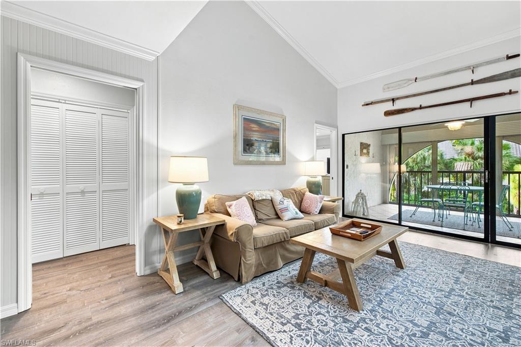 Vaulted ceilings, wood-finish flooring, louvered bi-fold closet doors, and sliding glass doors to a covered outdoor living area