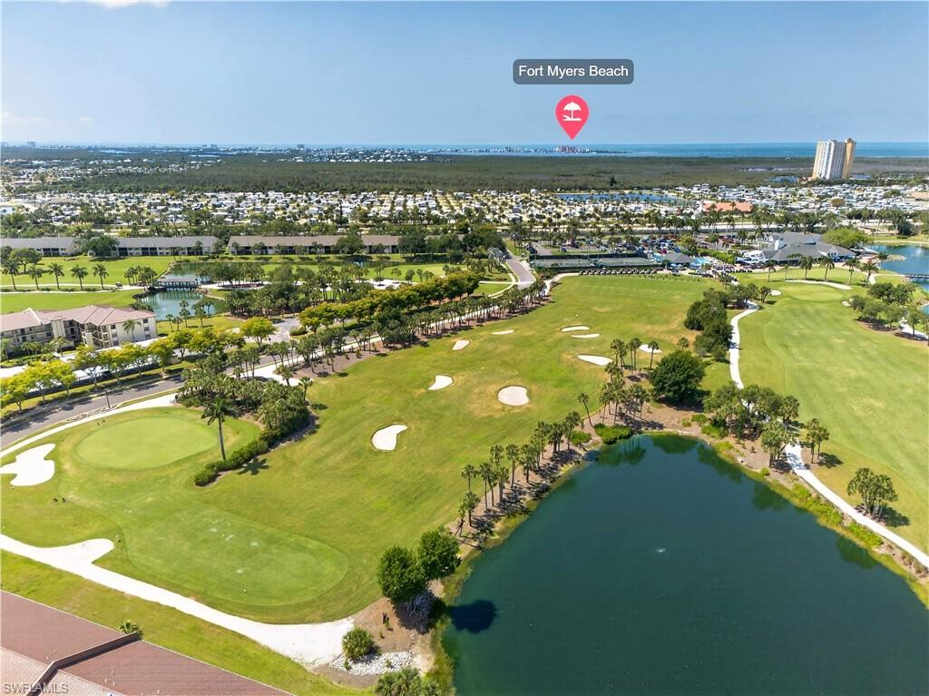 Expansive golf course with water features and mature palm trees