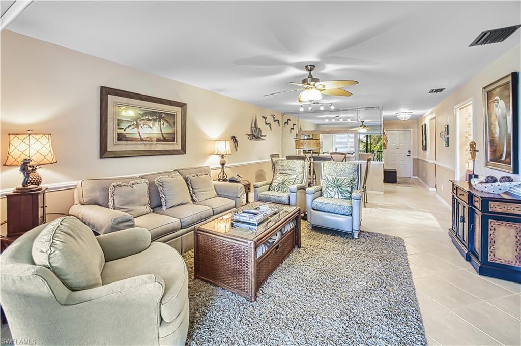 Recessed lighting with a ceiling fan, crown molding, and two-tone wall treatment