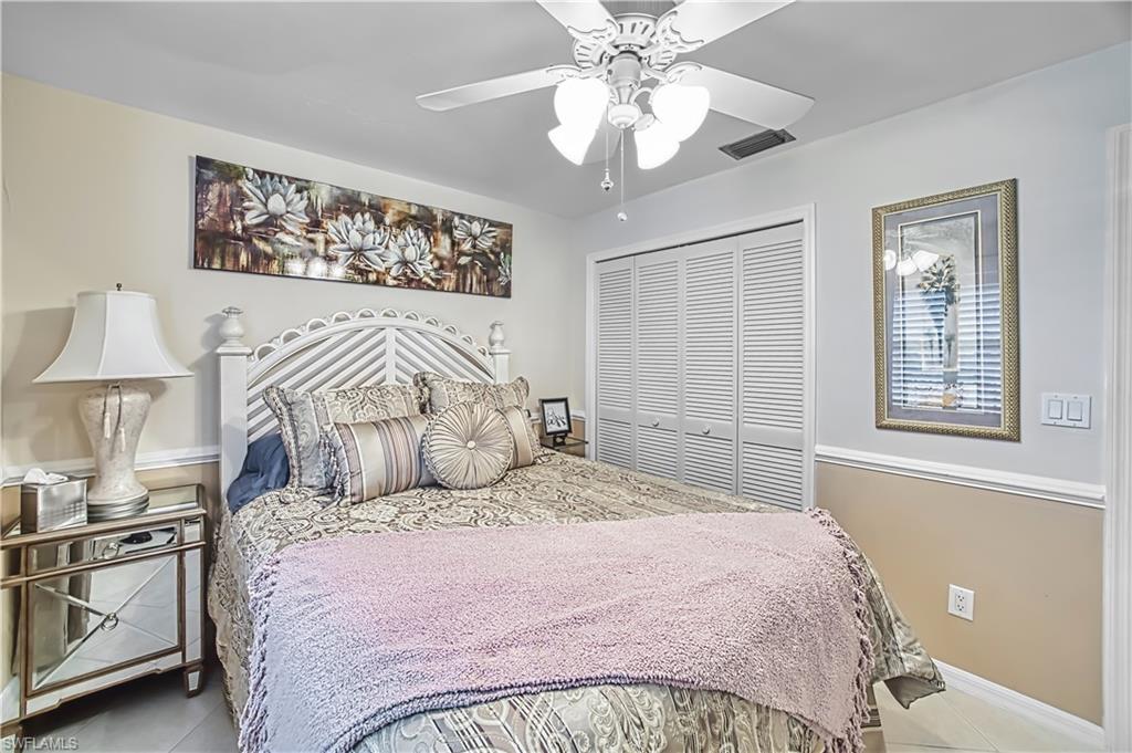 White louvered closet doors, ceiling fan with integrated lighting, and crown molding