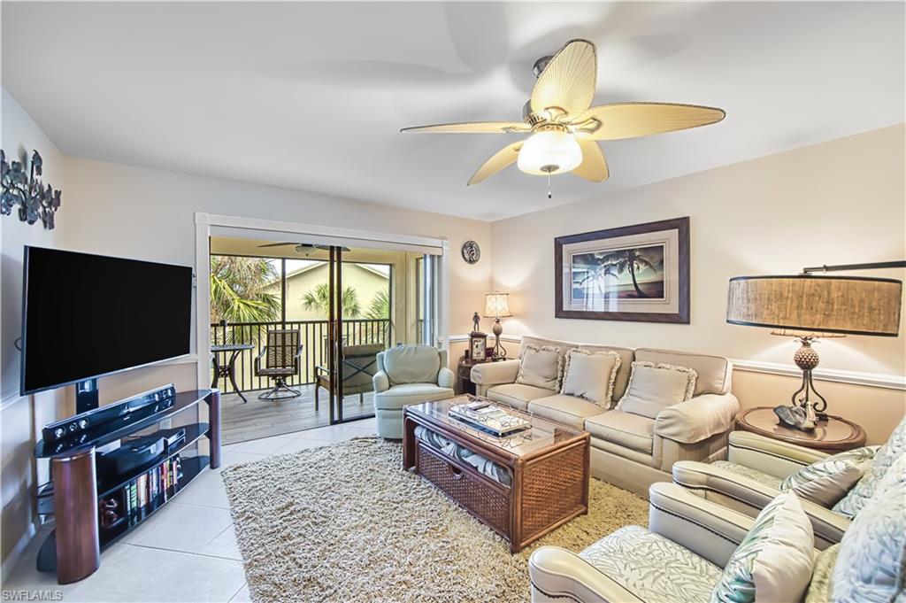 Tiled flooring throughout, ceiling fan with integrated lighting, crown molding, and direct access to an outdoor screened lanai