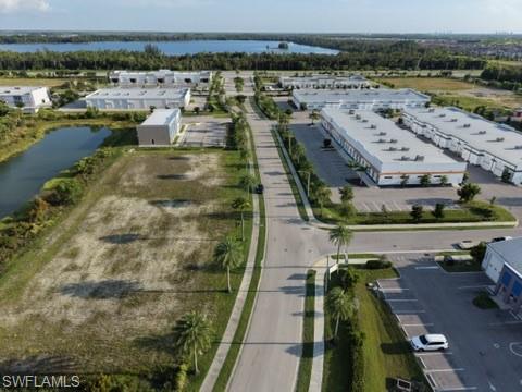 Expansive undeveloped lot featuring direct road frontage, established infrastructure, and proximity to a water body