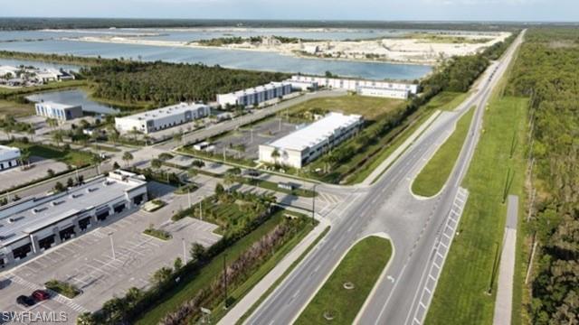 Paved road access, dedicated turn lanes, extensive parking areas, and adjacent commercial structures