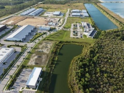 Expansive commercial development featuring multiple industrial buildings, paved roadways, and integrated retention ponds