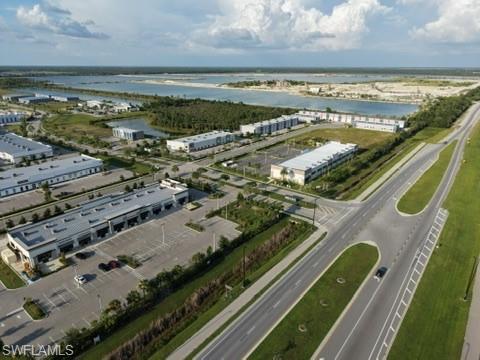 Commercial development featuring multiple buildings, surface parking, and road infrastructure