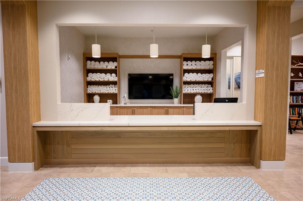 Custom built-in counter with a light-toned wood finish and a white stone-finish countertop