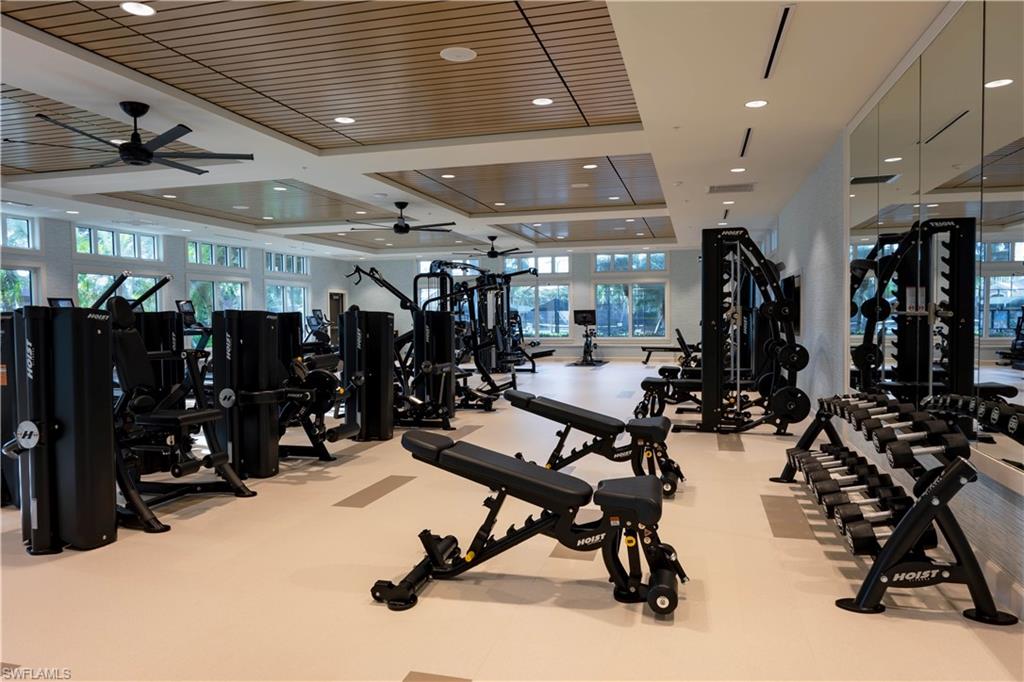 Dedicated fitness center with extensive exercise equipment, integrated ceiling fans, recessed lighting, expansive windows, and mirrored walls