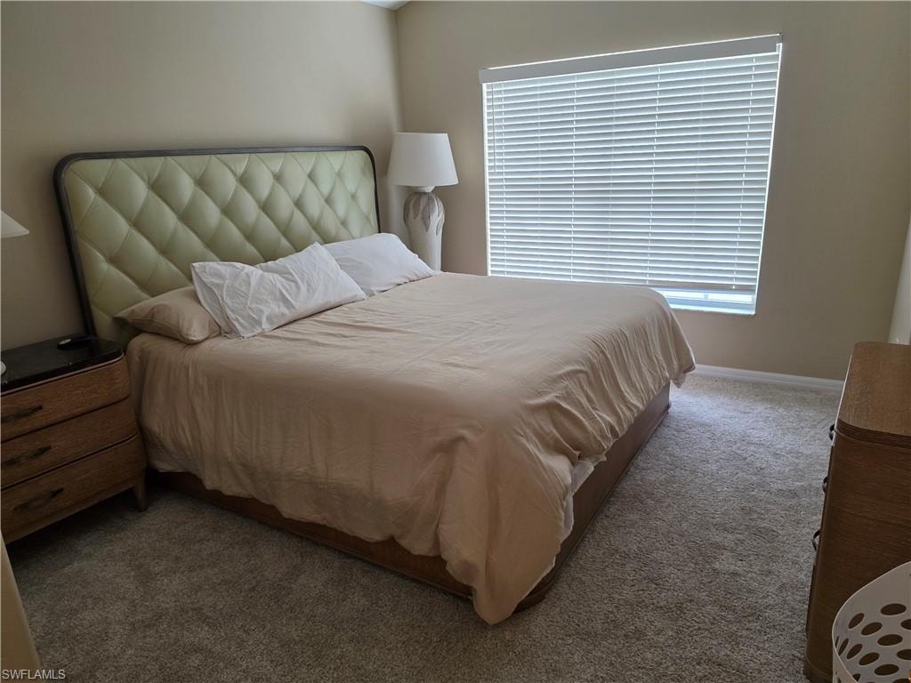Carpeted flooring, neutral wall paint, and a window with horizontal blinds