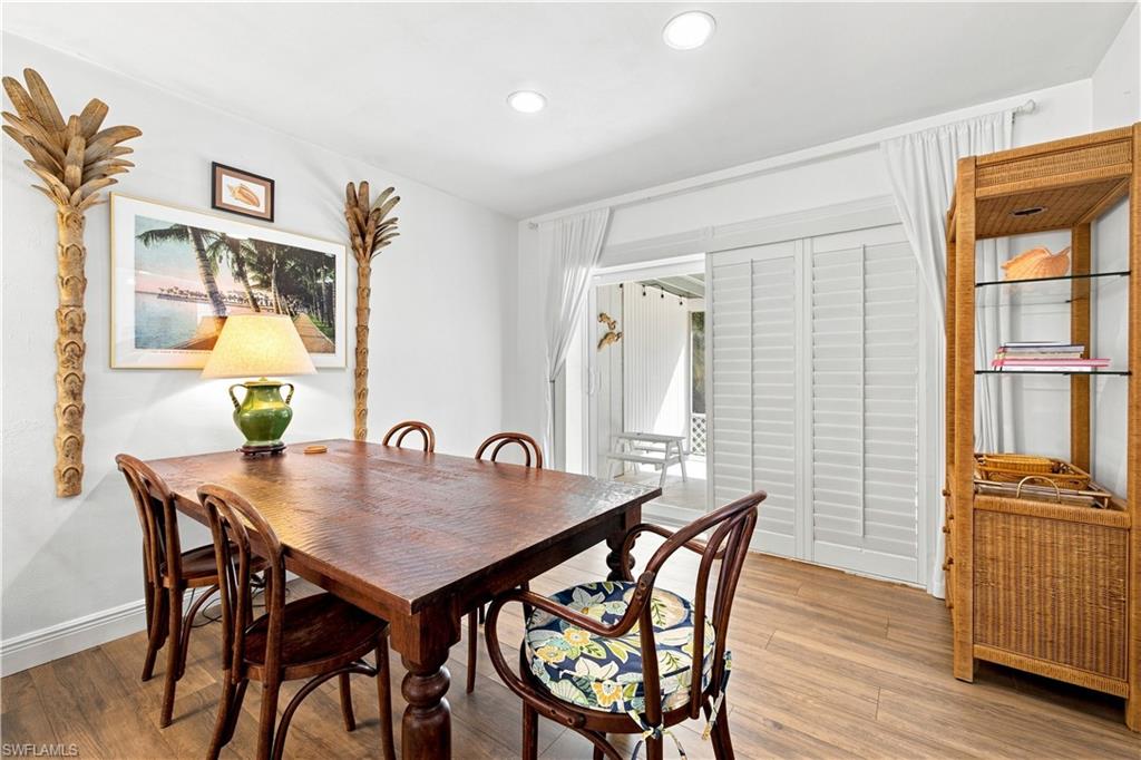 Wood-finish flooring, recessed lighting, plantation shutters, and sliding glass doors