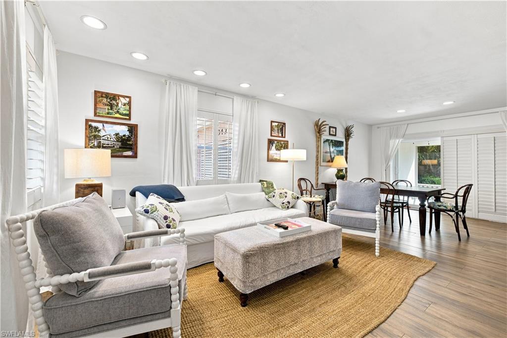 Recessed ceiling lighting, wood-finish flooring, and white plantation shutters