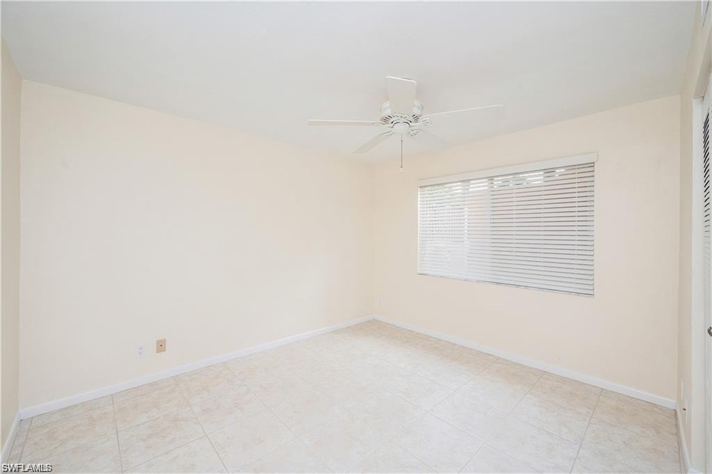 Unfurnished room featuring ceiling fan and baseboards