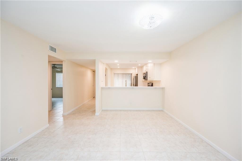 Unfurnished living room with recessed lighting and light tile patterned floors