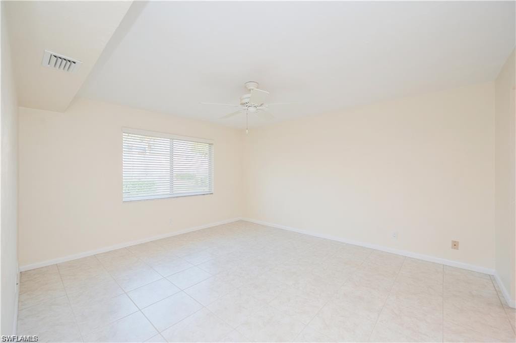 Empty room with ceiling fan and baseboards