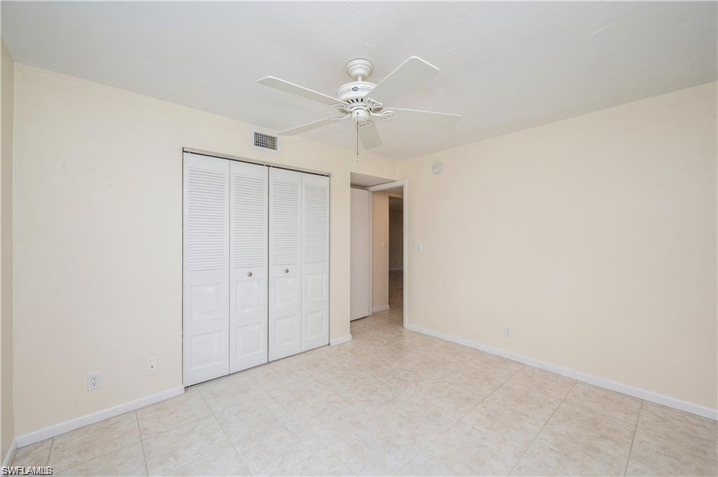Unfurnished bedroom with a closet and ceiling fan