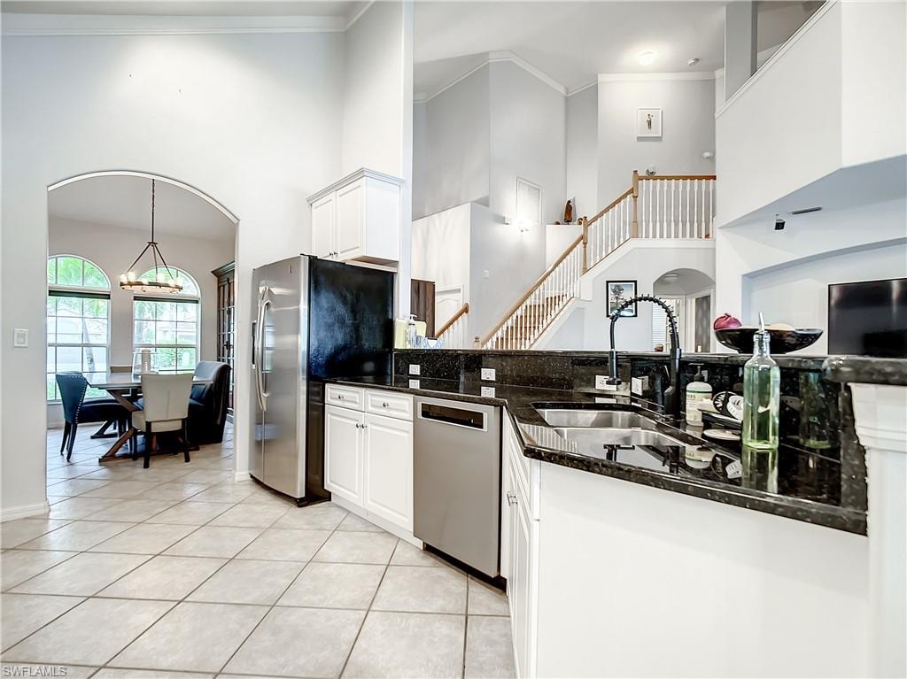 Gourmet kitchen featuring granite countertops, stainless steel appliances, and white cabinetry