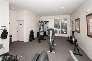 Dedicated fitness area with ample floor space, recessed lighting, and expansive windows