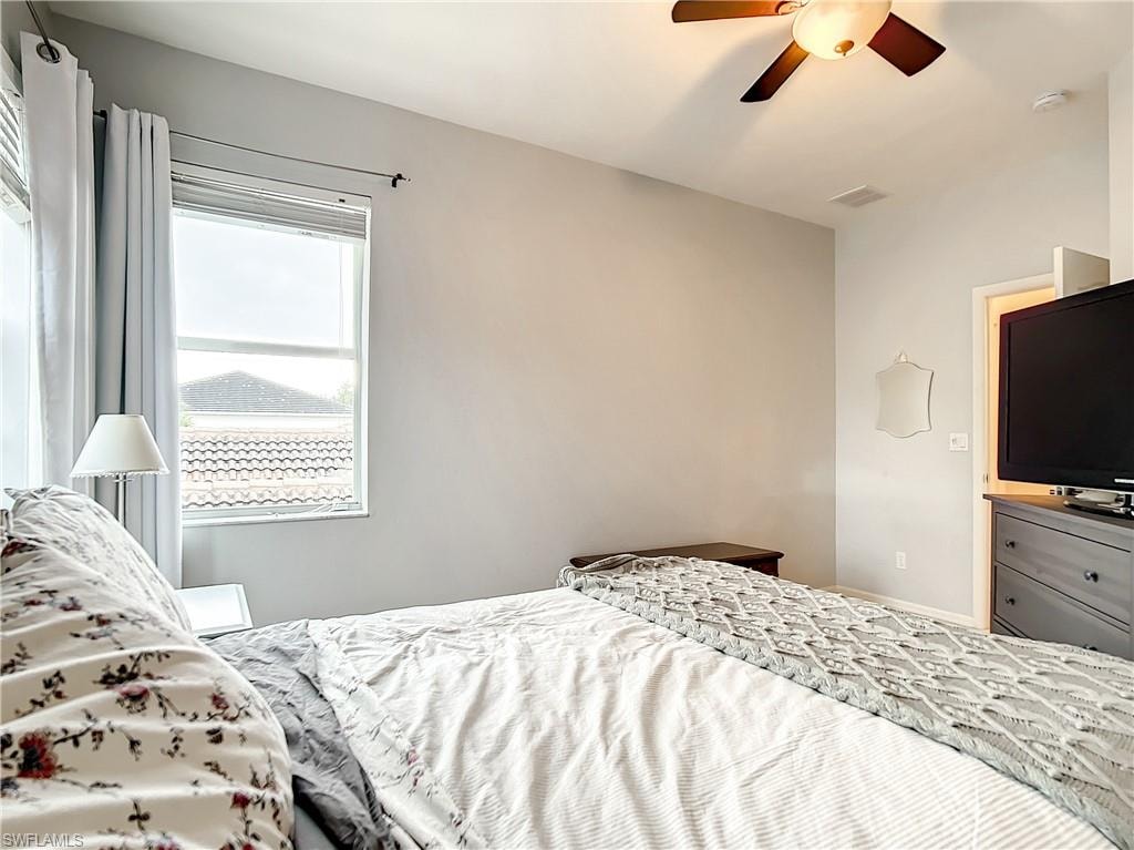 Window with horizontal blinds, light gray walls, and a ceiling fan