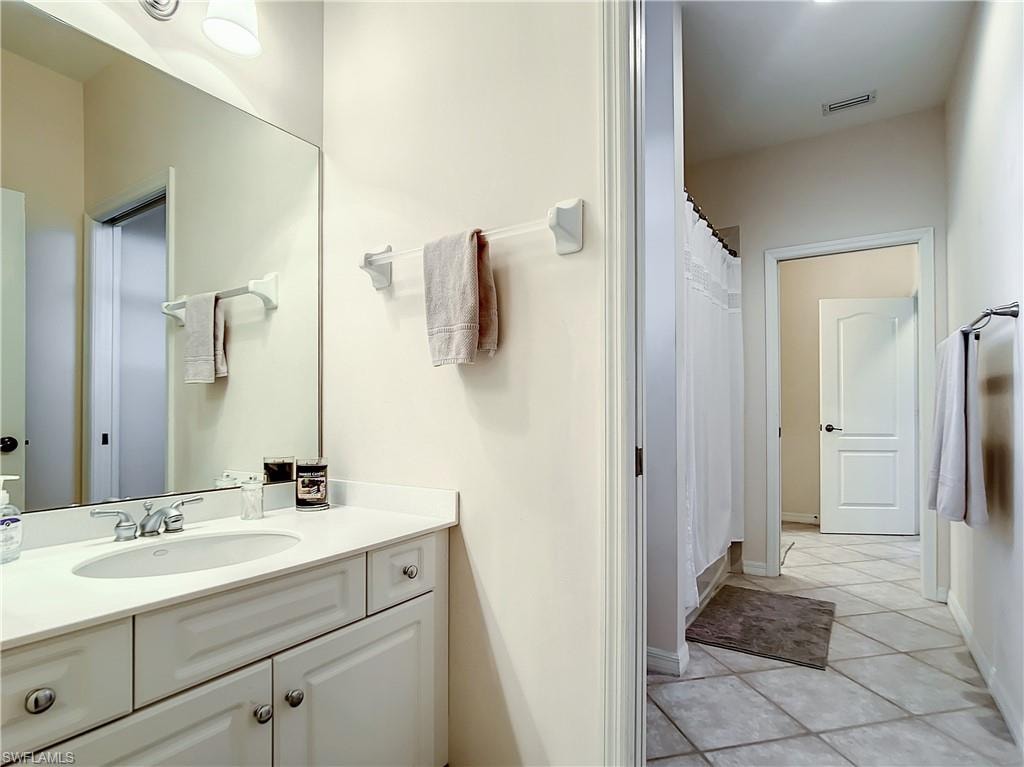 Vanity with an integrated sink, polished chrome faucet, and expansive mirror