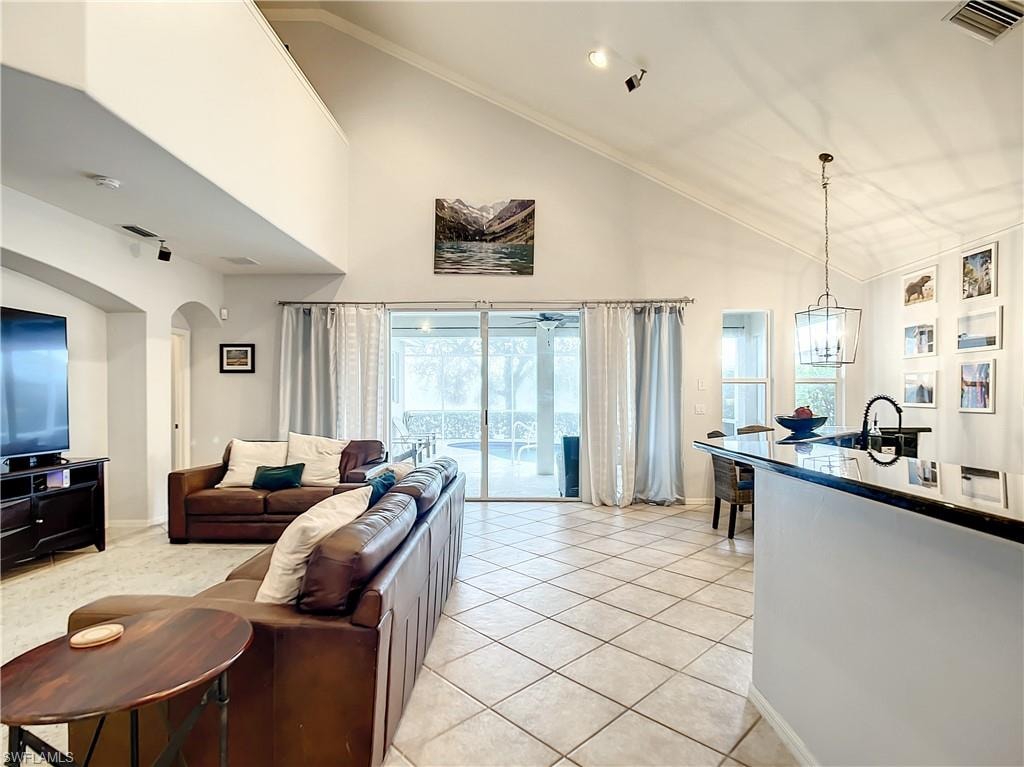 Vaulted ceilings with a ceiling fan, recessed lighting, and track lighting