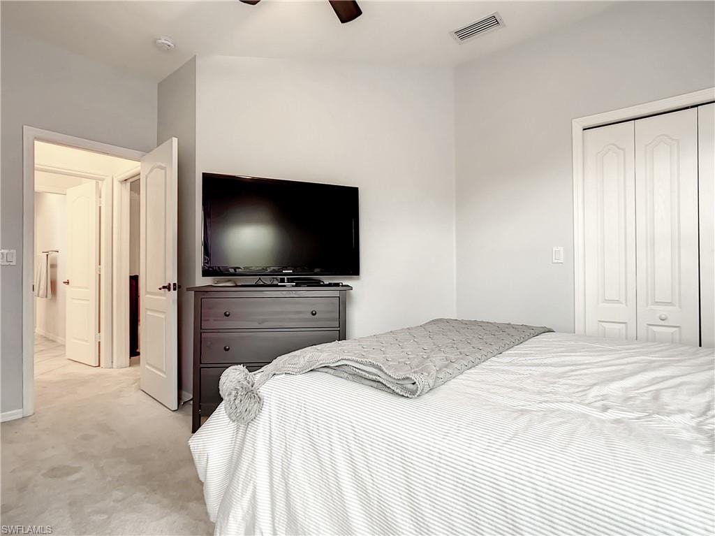 Neutral wall color, wall-to-wall carpeting, bi-fold closet doors, ceiling fan, and recessed lighting