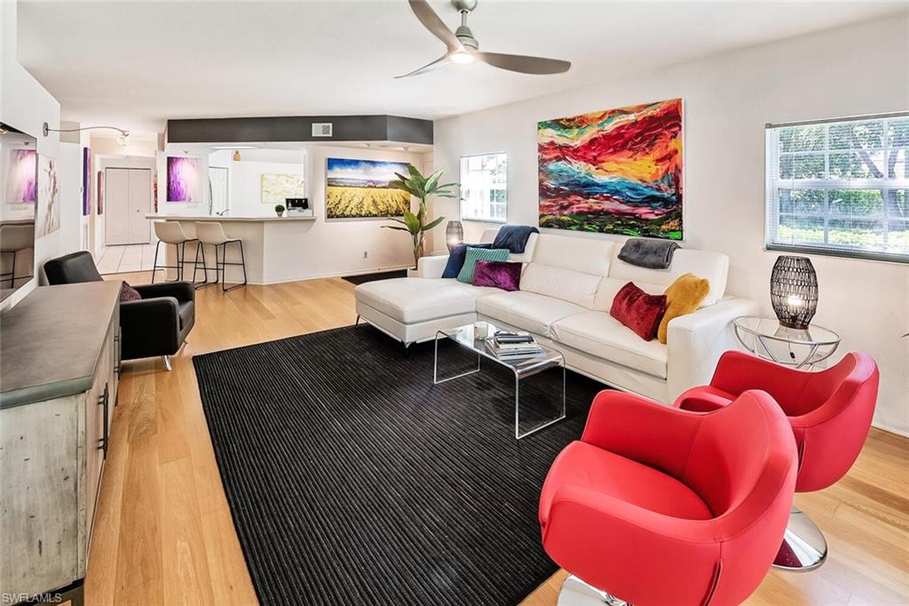 Living room featuring light wood-type flooring and ceiling fan