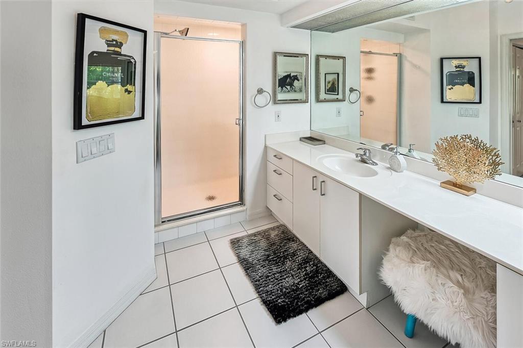 Bathroom featuring vanity, an enclosed shower, and tile patterned floors