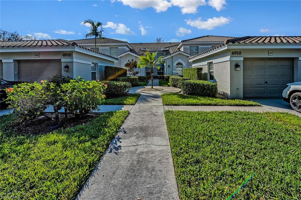 View of front of property with a garage and a front yard