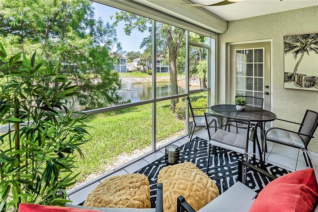Sunroom featuring a water view