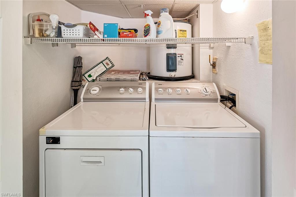 Washroom with water heater and washer and dryer