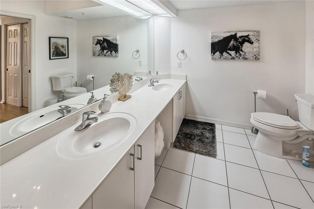 Bathroom with tile patterned flooring, vanity, and toilet