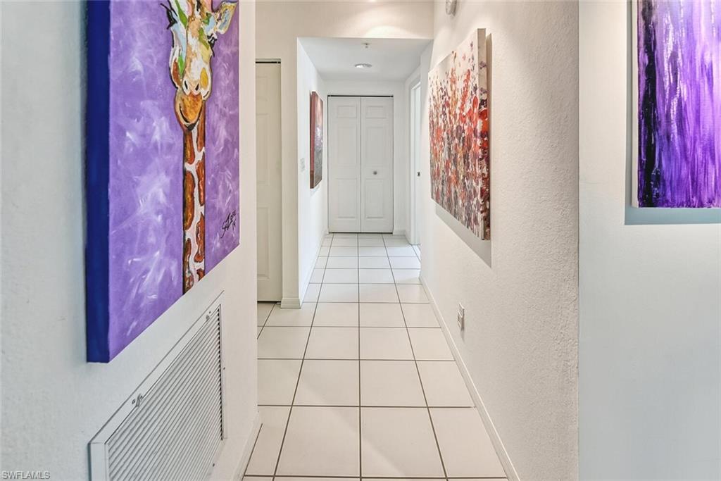 Corridor with light tile patterned floors