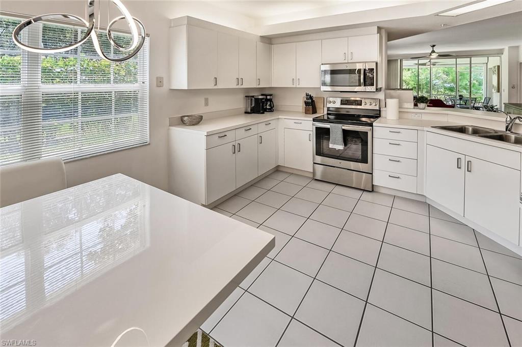 Kitchen featuring white cabinetry, ceiling fan, and stainless steel appliances