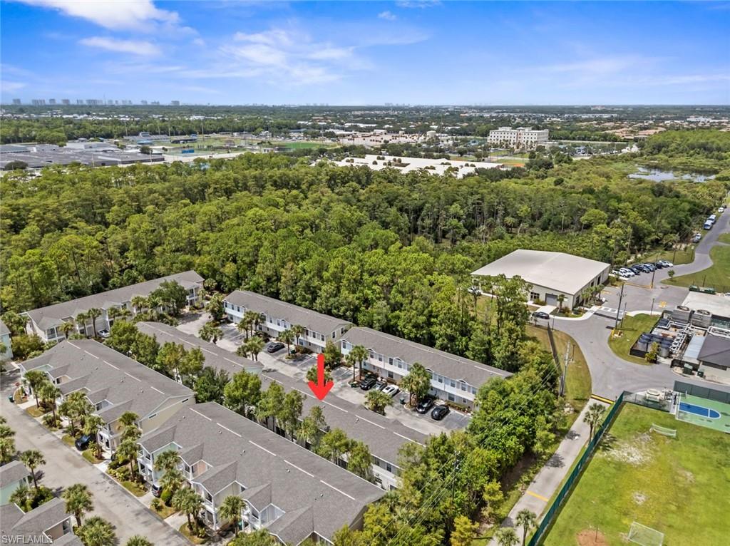 Townhome community with extensive surrounding greenery and a paved parking area