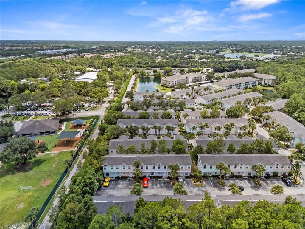 Townhome community with multiple structures, private parking areas, and mature landscaping