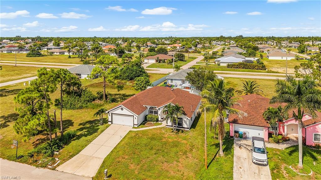 Single-story residence with a two-car garage, concrete driveway, and mature landscaping