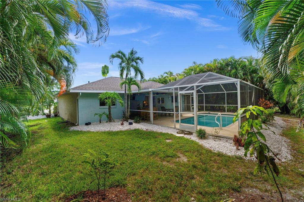 Yard is surrounded by tropical landscaping