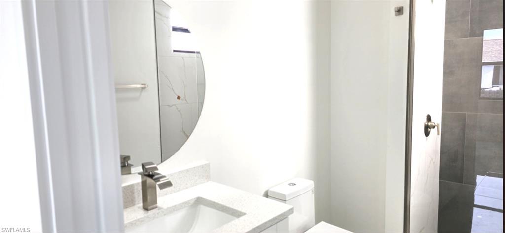 Vanity with a light-toned countertop and an undermount sink
