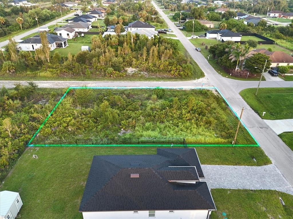 Expansive lot featuring natural vegetation, adjacent to paved roadways