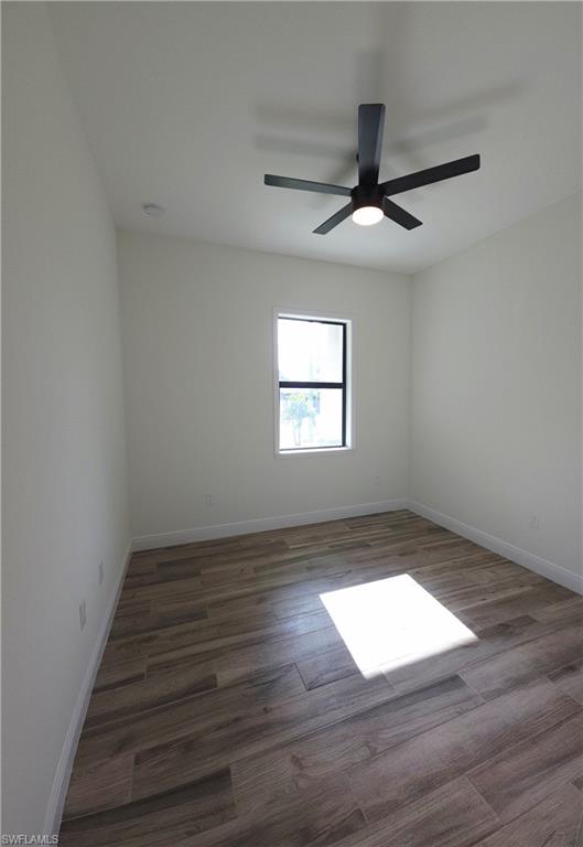 Bedroom 3, Wood-finish plank flooring, single window, white walls, and a ceiling fan with integrated lighting