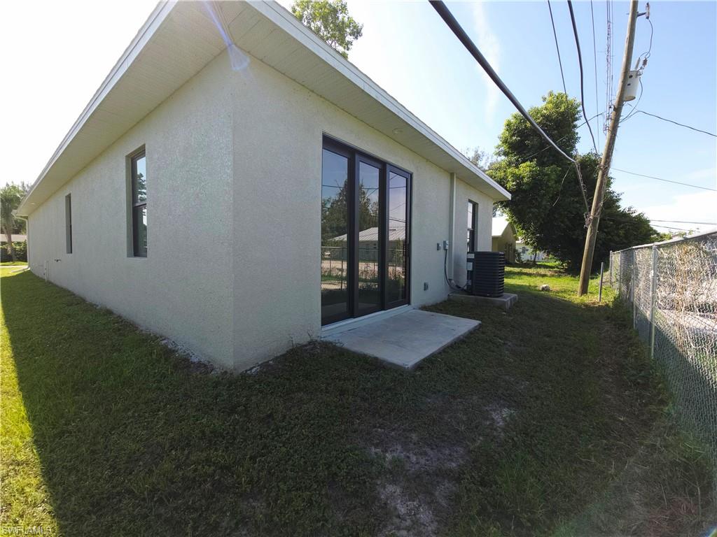 Rear of structure, stucco exterior with sliding door