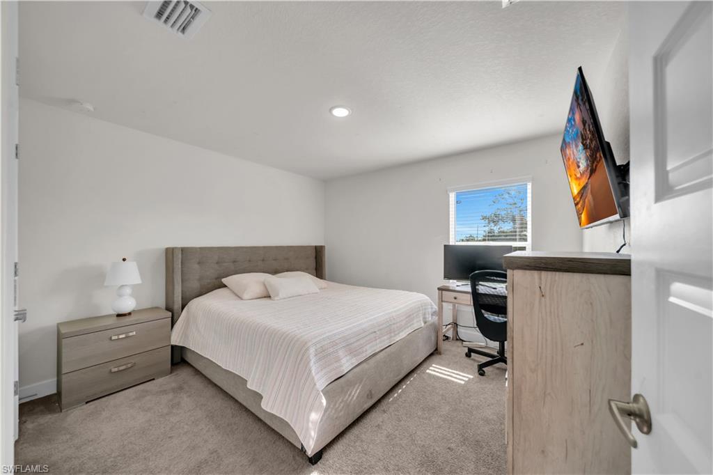 Carpeted flooring, recessed ceiling lighting, single window with blinds, and white painted walls