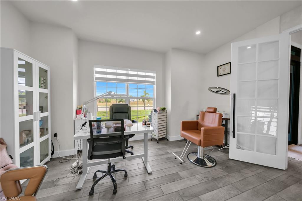 Recessed lighting illuminates wood-finish flooring