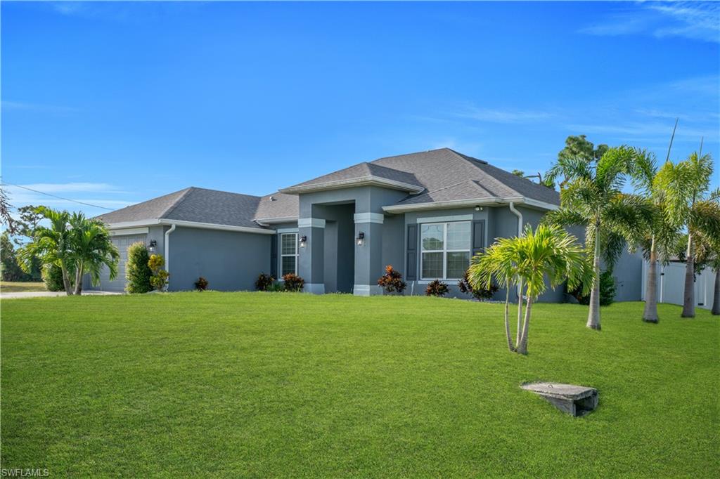 Contemporary single-story residence with a gray stucco exterior and dark gray shingle roof