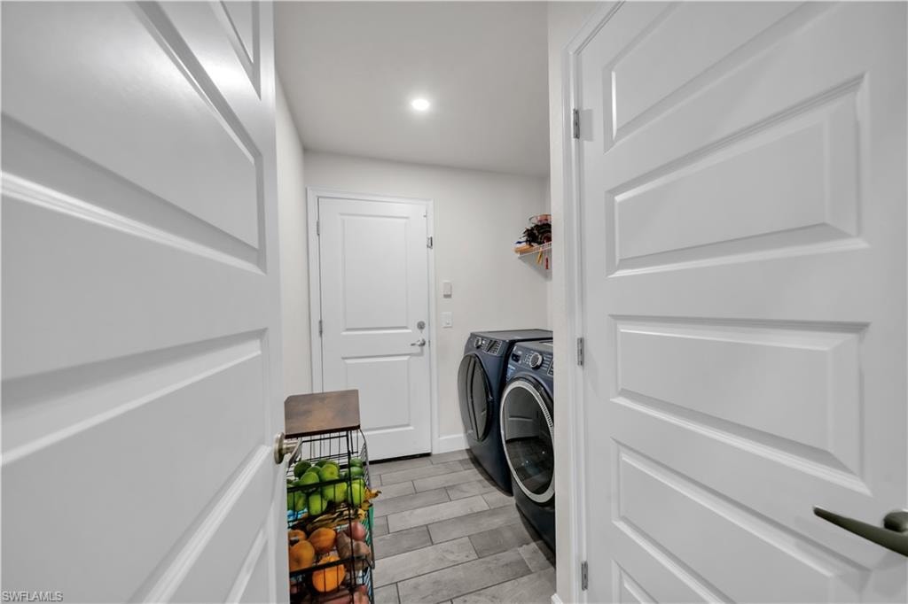 Laundry area with tiled flooring, white panel doors, and recessed lighting