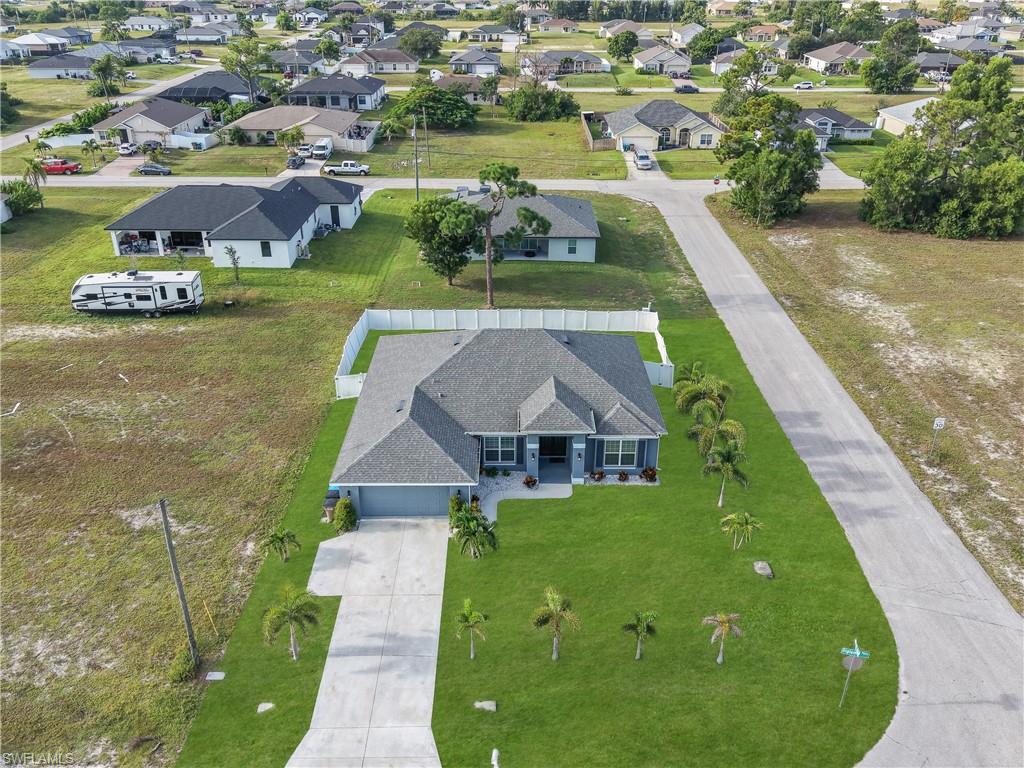 Single-story residence featuring a gray shingle roof and blue siding