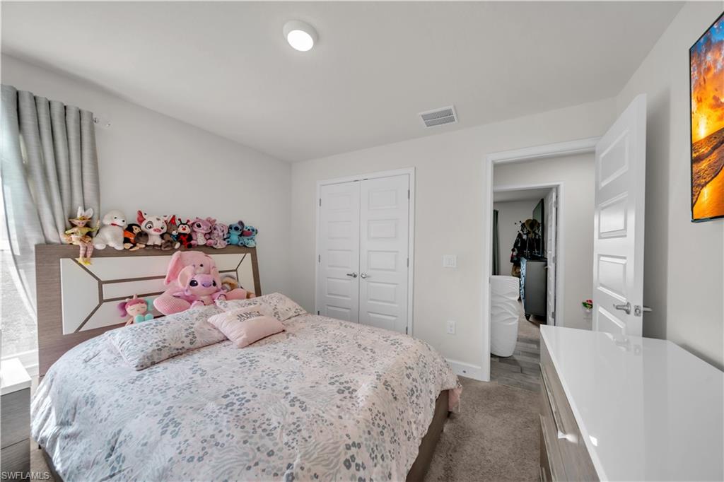 White paneled interior doors, recessed ceiling lighting, and carpet flooring