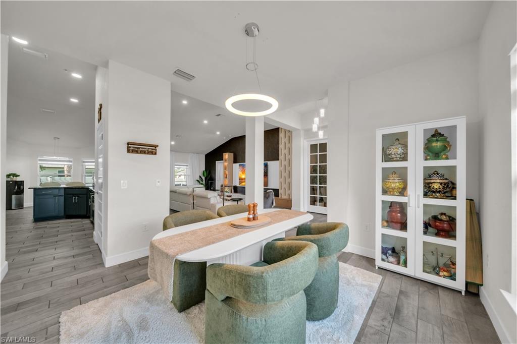 Vaulted ceilings, recessed lighting, and wood-finish flooring