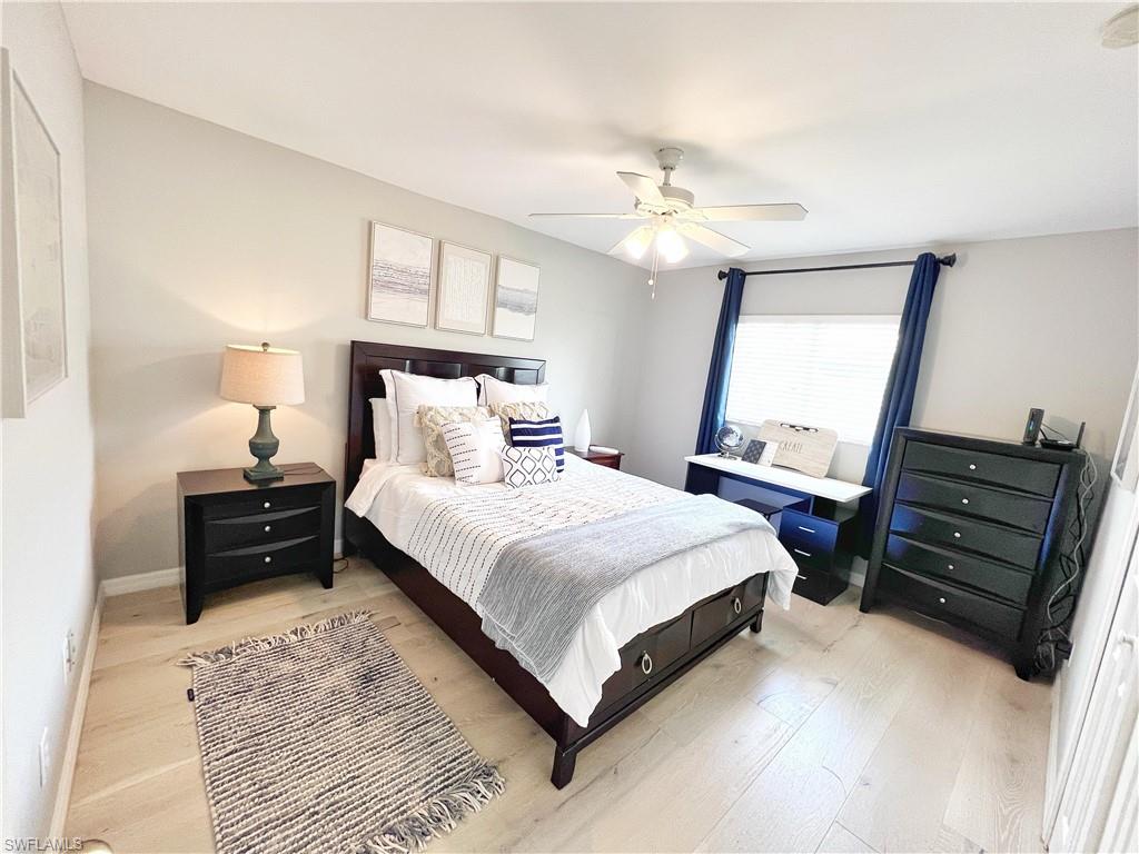 Bedroom with light wood-style flooring and a ceiling fan