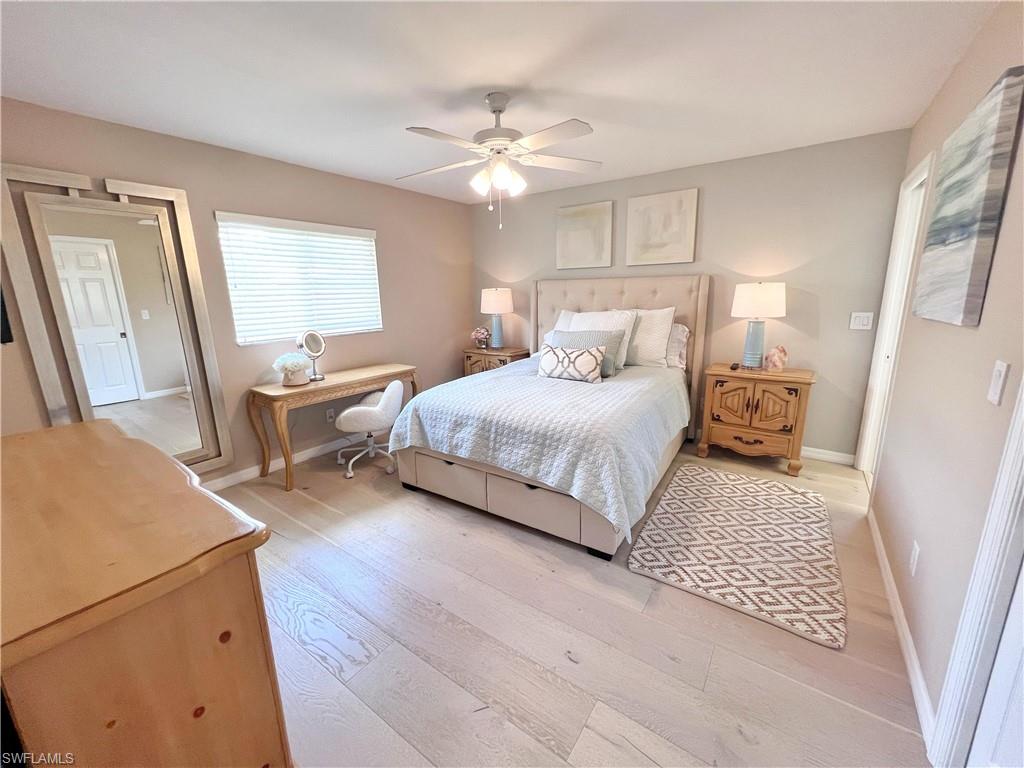 Bedroom with light wood-style floors and a ceiling fan