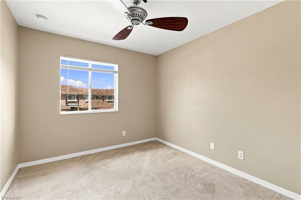 Window with horizontal blinds, ceiling fan with wood-finish blades, recessed lighting, and neutral carpet flooring